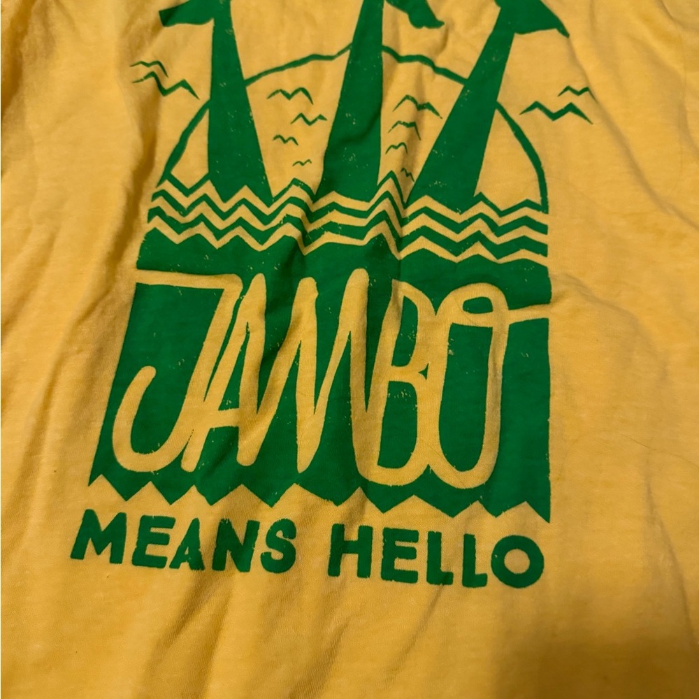 Yellow T-Shirt with Green "Jambo Means Hello" Graphic